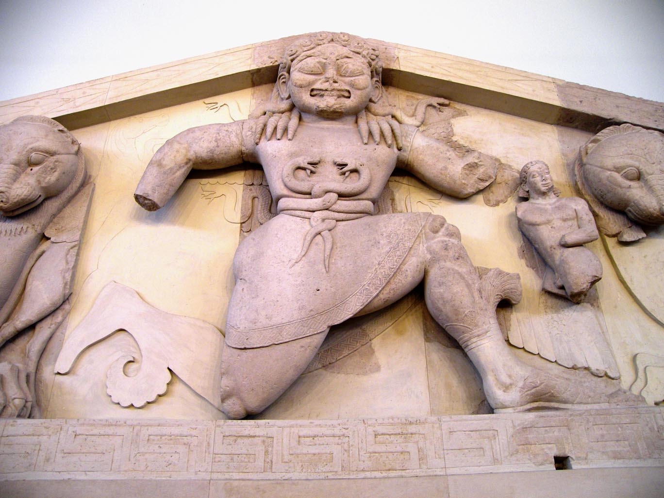 An archaic Gorgon (around 580 BC), as depicted on a pediment from the temple of Artemis in Corfu, on display at the Archaeological Museum of Corfu. (https://commons.wikimedia.org/w/index.php?curid=16700263)