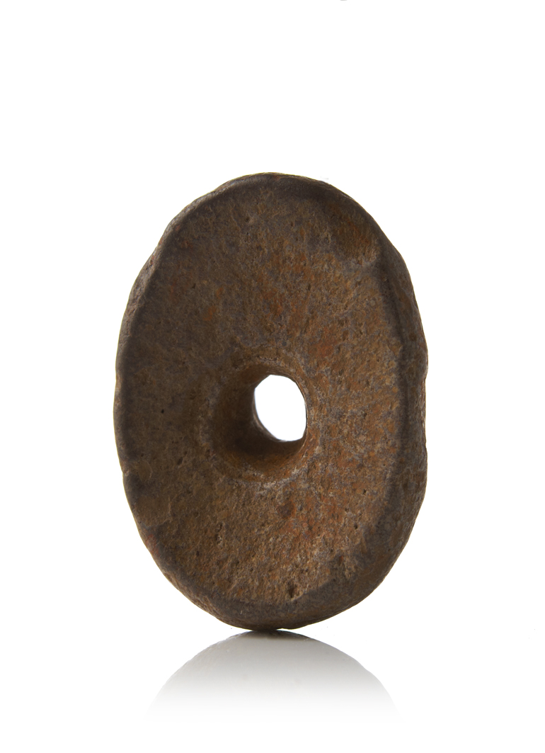 Example of a hag stone with its natural perforation. The power of such stones was sometimes increased by the addition of iron keys attached using twine and hung alongside one another ©Scarborough Museums Trust Photographer: David Chalmers