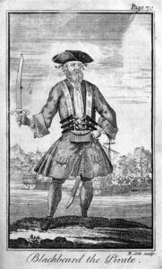 Blackbeard, by Engraved by Benjamin Cole[1] (1695–1766) - Defoe, Daniel; Johnson, Charles (1724) "Capt. Teach alias Black-Beard" in A General History of the Pyrates: From Their First Rise and Settlement in the Island of Providence, to the Present Time. With the Remarkable Actions and Adventures of the Two Female Pyrates Mary Read and Anne Bonny. To Which is Added. A Short Abstract of the Statute and Civil Law, in Relation to Pyracy. (Second Edition ed.), London: T. Warner, pp. plate facing p. 70 Retrieved on 8 April 2010., Public Domain, https://commons.wikimedia.org/w/index.php?curid=10112479