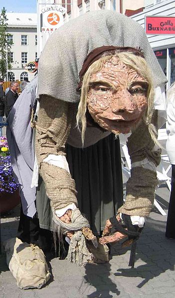 Large street puppet of a bent over old woman
