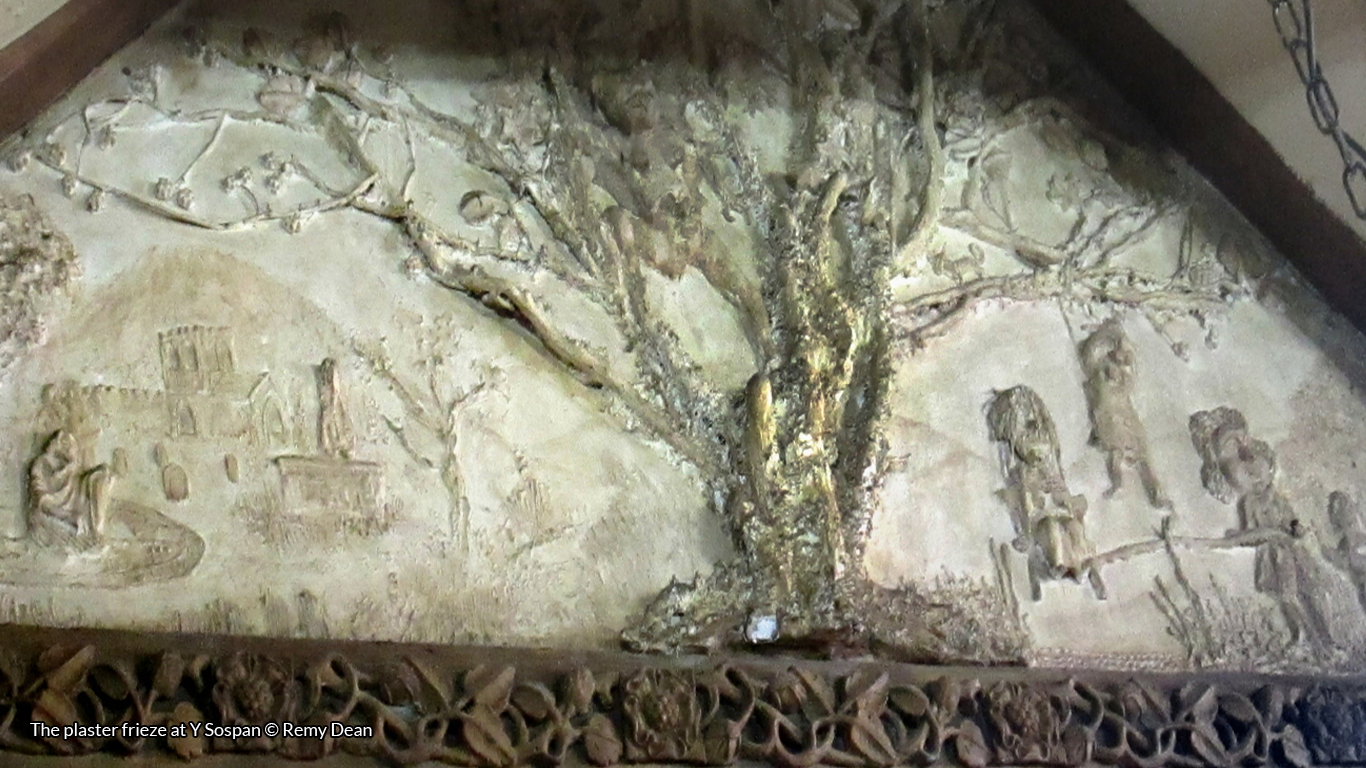 The plaster frieze at Y Sospan showing a tree with hanged people swinging from it.