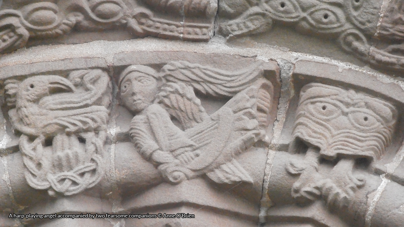 A harp-playing angel accompanied by two fearsome companions © Anne O'Brien