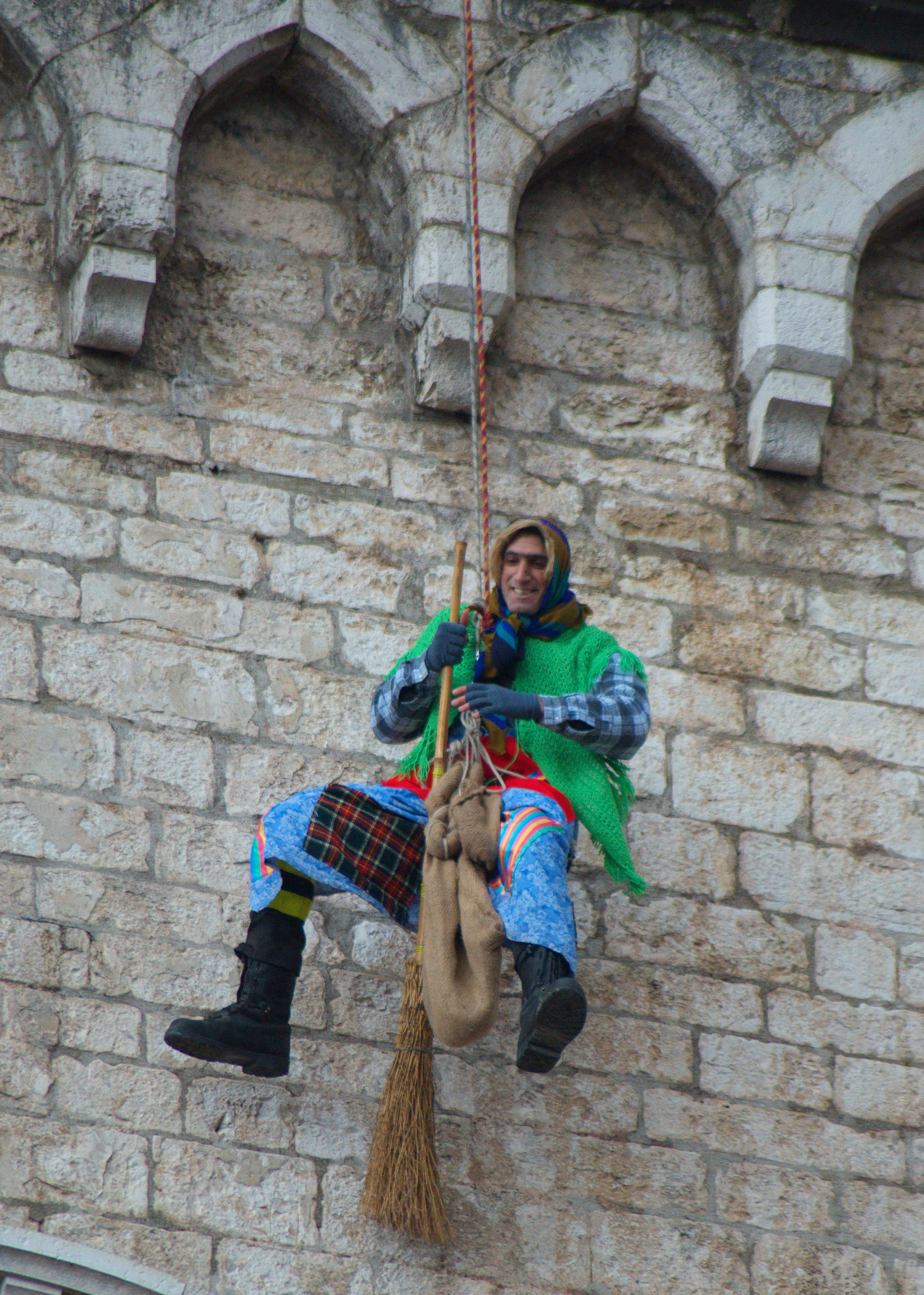 An Italian firefighter dressed up as the Befana descends from Gubbio’s medieval buildings. By Beatrice - Own work, CC BY-SA 3.0, https://commons.wikimedia.org/w/index.php?curid=17930291