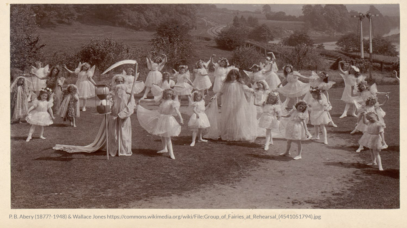 Group of little girls dressed as fairies rehersing for their play.