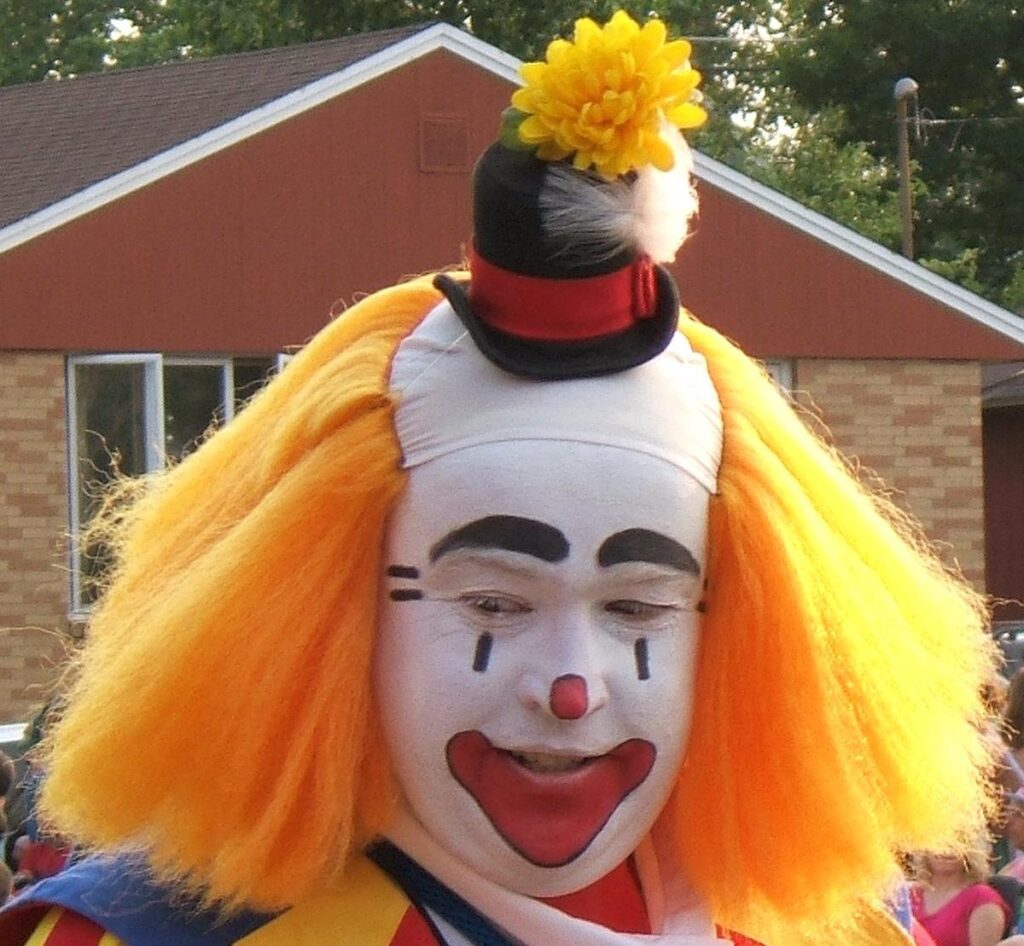 Clown with orange hair. By photo taken by flickr user *Micky* - flickr, CC BY 2.0, https://commons.wikimedia.org/w/index.php?curid=1887219