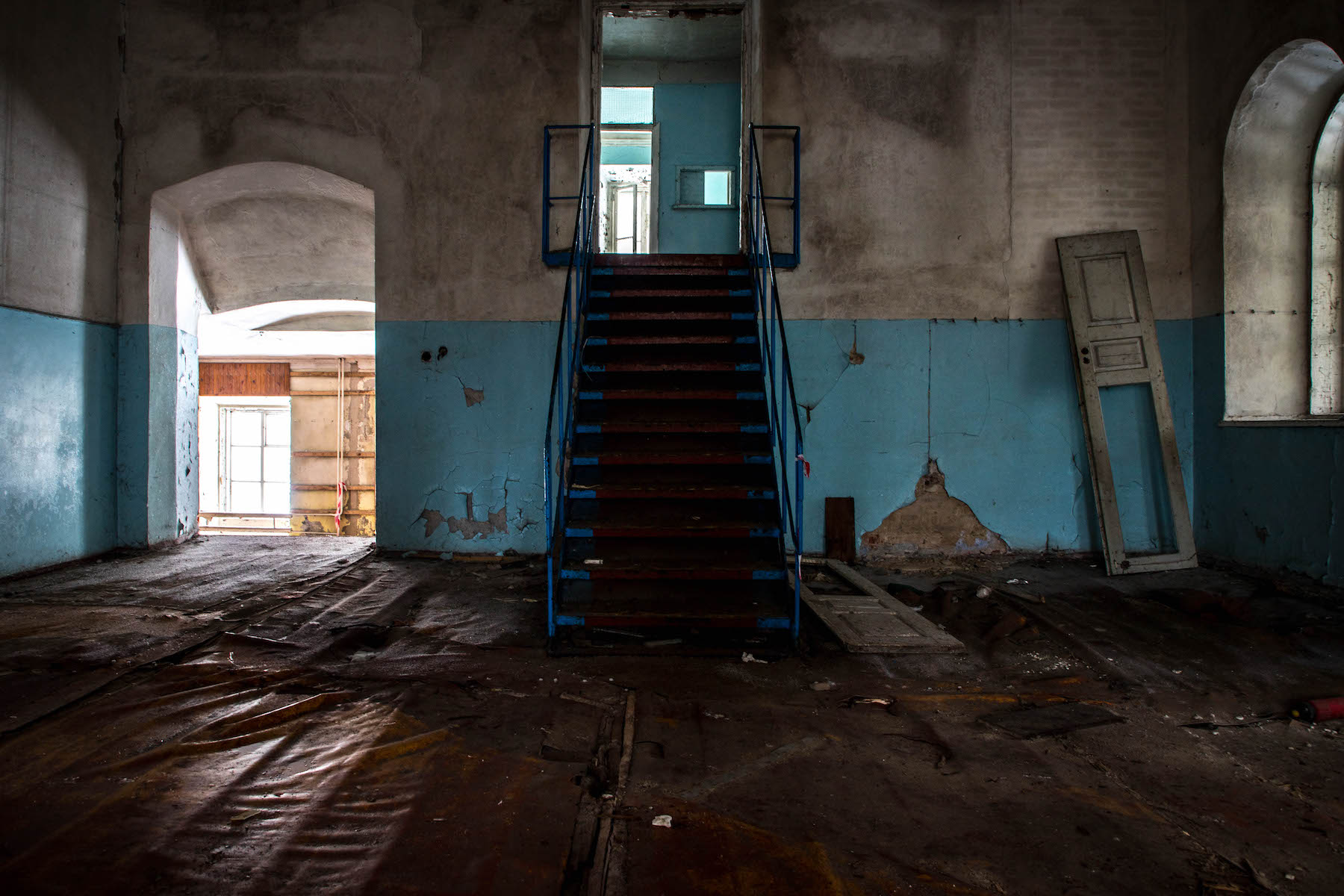 The main hall inside the former synagogue in Chernobyl town. Originally the heart of Chernobyl’s Jewish community, after WWII and the loss of many Jewish lives, this building was commandeered by the Soviet military, who used it until the disaster as a recruitment office. Today it is abandoned and severely decayed. © Darmon Richter